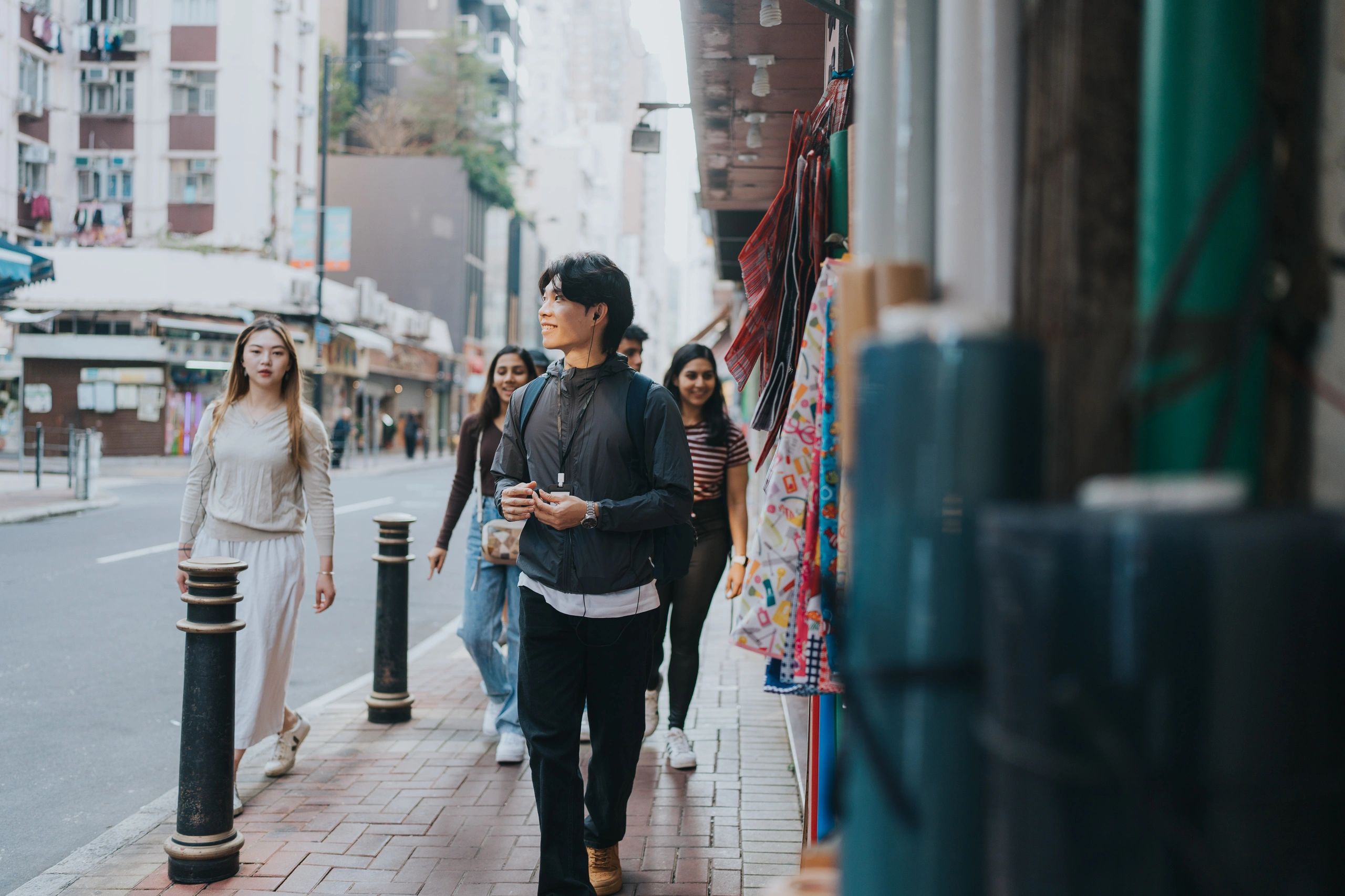 Travelers exploring a lively street with a local guide