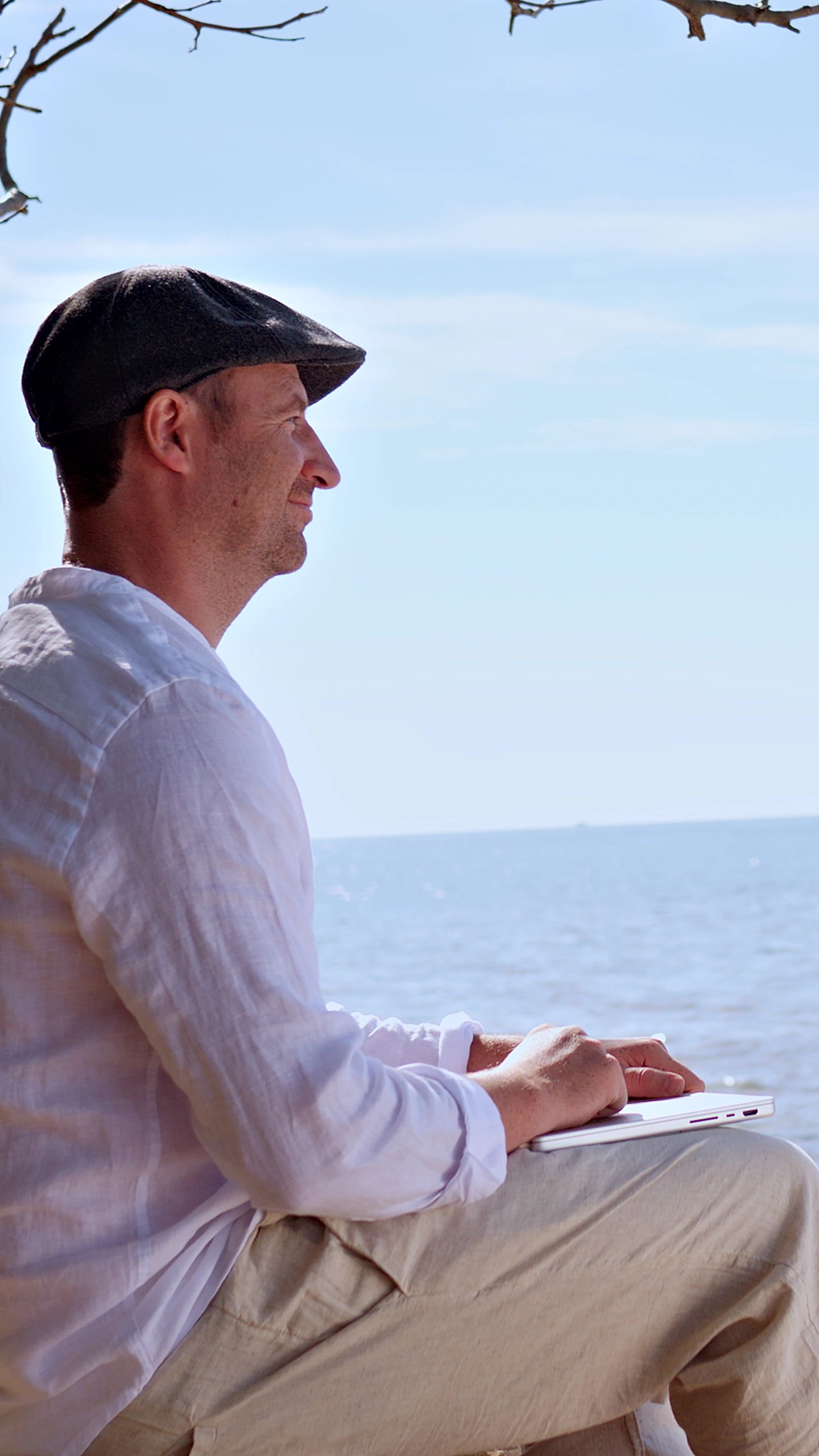 Travel writer reflecting by the sea